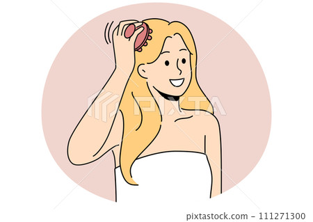 Woman in towel massage head with scalp brush 111271300