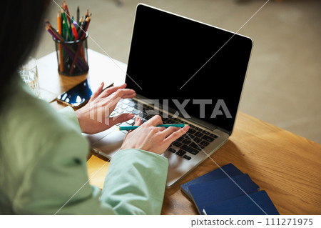 Focus on female hands typing on laptop, planning vacation, looking for tours, choosing hotels, accommodations and tour services Focus on female hands typing on laptop, planning vacation, looking for tours, choosing hotels, accommodations and tour services 111271975