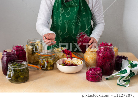 Woman fermenting fresh vegetables 111272073