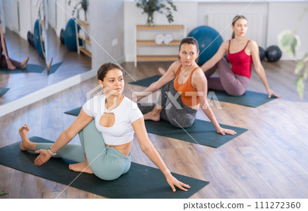 Group of women doing yoga in studio 111272360
