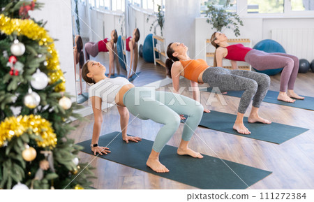 Group of women doing pilates in studio Group of women doing pilates in studio 111272384