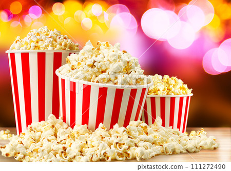 Popcorn in red and white striped paper buckets at the cinema. Popcorn stand 111272490