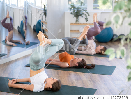 Group of women doing yoga in studio 111272539