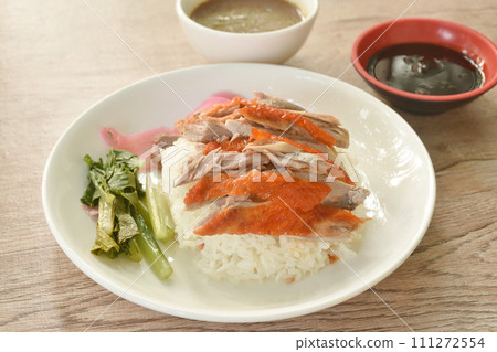 slice roasted duck topping rice with pink pickled ginger and boiled cabbage dressing sweet soy sauce on plate slice roasted duck topping rice with pink pickled ginger and boiled cabbage dressing sweet soy sauce on plate 111272554