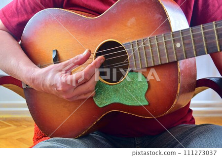 Closeup of man's hands playing acoustic guitar. Musical concept 111273037