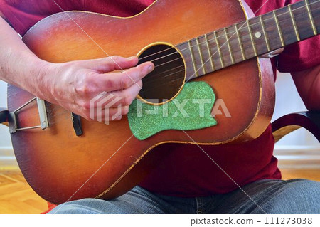 Male hand playing on acoustic guitar. Close-up. Musical concept Male hand playing on acoustic guitar. Close-up. Musical concept 111273038