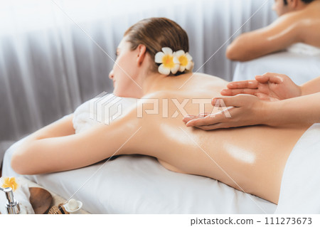 Caucasian couple customer enjoying relaxing anti-stress massage. Quiescent Caucasian couple customer enjoying relaxing anti-stress massage. Quiescent 111273673