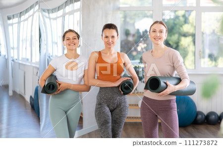 Group of women posing with yoga mats 111273872