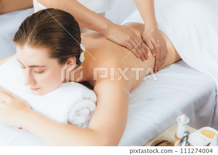 Caucasian couple customer enjoying relaxing anti-stress massage. Quiescent Caucasian couple customer enjoying relaxing anti-stress massage. Quiescent 111274004