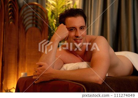 Caucasian man customer enjoying relaxing anti-stress massage. Quiescent Caucasian man customer enjoying relaxing anti-stress massage. Quiescent 111274049