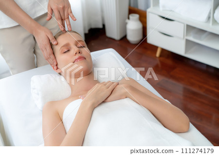 Caucasian woman enjoying relaxing anti-stress head massage. Quiescent Caucasian woman enjoying relaxing anti-stress head massage. Quiescent 111274179