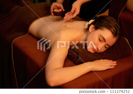 Woman customer having exfoliation treatment in luxury spa. Quiescent 111274252