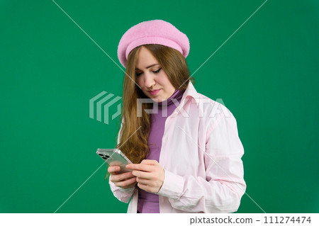 Girl crop view in casual pink hoodie using smartphone isolated on white, mobile social media Girl crop view in casual pink hoodie using smartphone isolated on white, mobile social media 111274474