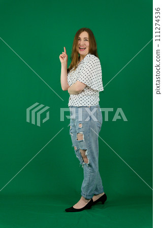 young woman in a white T-shirt in jeans in full growth on a grren background young woman in a white T-shirt in jeans in full growth on a grren background 111274536