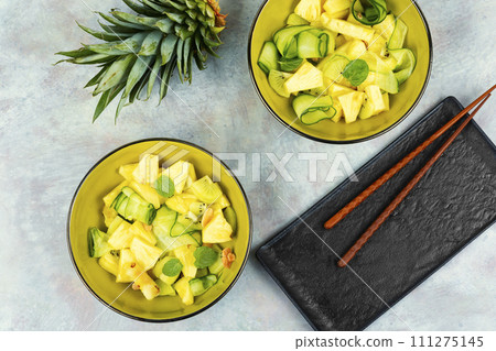 Healthy pineapple and cucumber salad. 111275145