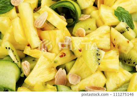 Juicy pineapple and cucumber salad, close up. 111275146
