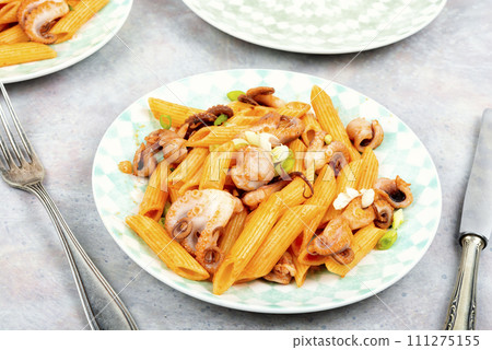 Macaroni with octopus pieces. Macaroni with octopus pieces. 111275155