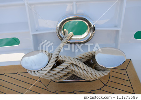 Stainless steel cleat on a superyacht. Mooring arrangements. Rollers. Marine hardware. Mooring. Stainless steel cleat on a superyacht. Mooring arrangements. Rollers. Marine hardware. Mooring. 111275589