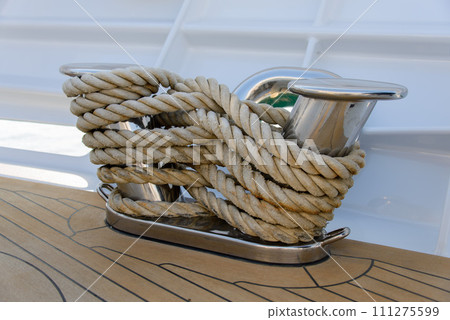 Stainless steel cleat on a superyacht. Mooring arrangements. Rollers. Marine hardware. Mooring. Stainless steel cleat on a superyacht. Mooring arrangements. Rollers. Marine hardware. Mooring. 111275599