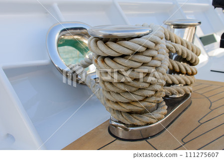 Stainless steel cleat on a superyacht. Mooring arrangements. Rollers. Marine hardware. Mooring. Stainless steel cleat on a superyacht. Mooring arrangements. Rollers. Marine hardware. Mooring. 111275607