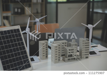 Close-up at tablet, Engineers pointing at tablet with their hands. To jointly design the use of renewable energy with wind and solar energy. Concept of using renewable energy. Close-up at tablet, Engineers pointing at tablet with their hands. To jointly design the use of renewable energy with wind and solar energy. Concept of using renewable energy. 111275907