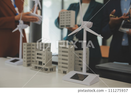 Close-up at tablet, Engineers pointing at tablet with their hands. To jointly design the use of renewable energy with wind and solar energy. Concept of using renewable energy. 111275937