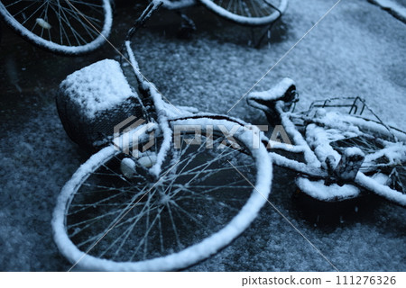 Snow accumulating on a fallen bicycle Snow accumulating on a fallen bicycle 111276326