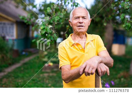 Portrait of mature farmer with shovel on garden Portrait of mature farmer with shovel on garden 111276378