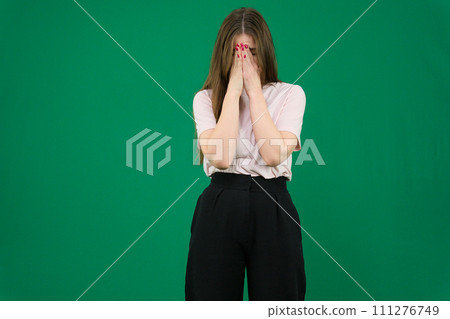 Young redhead woman with apron with tired and sick expression over green background 111276749