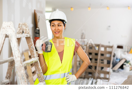 Portrait of asian woman builder with drill Portrait of asian woman builder with drill 111276842