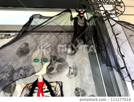 Bat on door Trick or Treat Halloween decorations at home Witches hung on porch Introducing Skeletons, Bones America brightly celebrate Halloween house is ready to receive children to give them sweets Bat on door Trick or Treat Halloween decorations at home Witches hung on porch Introducing Skeletons, Bones America brightly celebrate Halloween house is ready to receive children to give them sweets 111277018