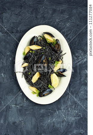 Mussels and black pasta. 111277084