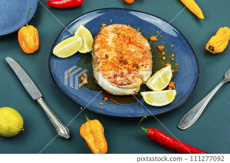 Grilled salmon steak in orange marinade. 111277092