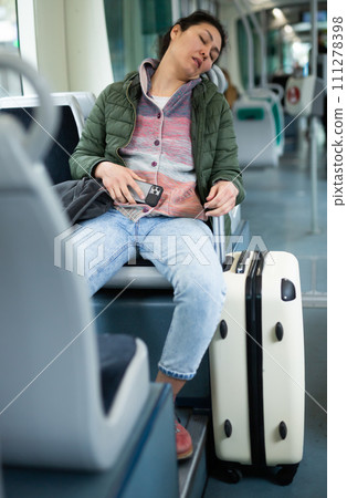 Young woman passenger sleeping in tram 111278398