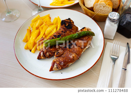traditional spanish fried pettitoe with fries served on black plate on wooden table traditional spanish fried pettitoe with fries served on black plate on wooden table 111278488