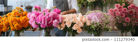 Five bouquets of flowers on the blurred background of a flower shop. 111279340