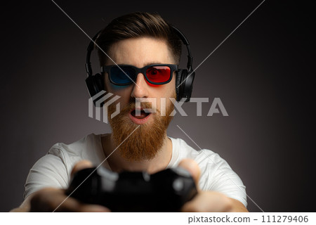 Photo of excited funky man wear t-shirt enjoying playstation game Photo of excited funky man wear t-shirt enjoying playstation game 111279406