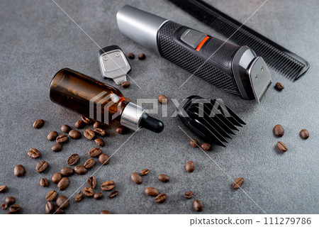 Trimmer with nozzles. Buying a new wireless trimmer. On a stone background. Close-up. With a space for text 111279786