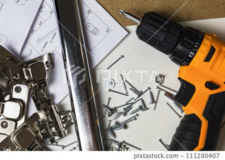 Furniture fittings. Furniture assembly hardware options and tools on a white background. 111280407