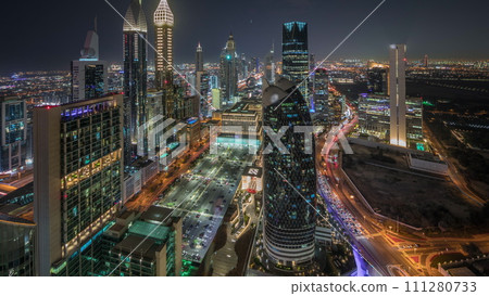 Skyline view of the high-rise buildings on Sheikh Zayed Road in Dubai aerial night timelapse, UAE. 111280733
