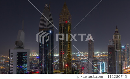 Skyline view of the high-rise buildings on Sheikh Zayed Road in Dubai aerial all night timelapse, UAE. 111280743