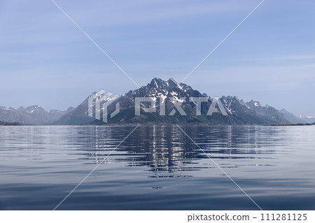 Lofoten Islands' serene snow-capped peaks mirrored on glassy fjord surface, Norway's tranquility 111281125