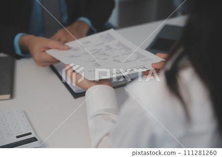 Close up view of job interview in office, focus on resume writing tips, employer reviewing good cv of prepared skilled applicant, recruiter considering application, hr manager making hiring decision Close up view of job interview in office, focus on resume writing tips, employer reviewing good cv of prepared skilled applicant, recruiter considering application, hr manager making hiring decision 111281260