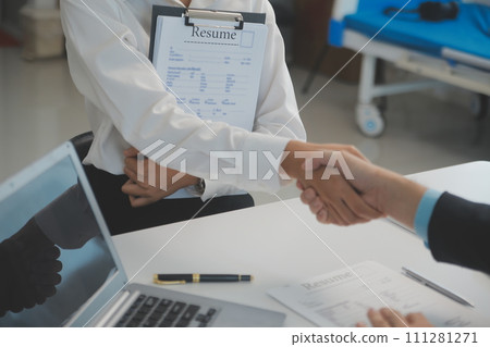 Close up view of job interview in office, focus on resume writing tips, employer reviewing good cv of prepared skilled applicant, recruiter considering application, hr manager making hiring decision 111281271