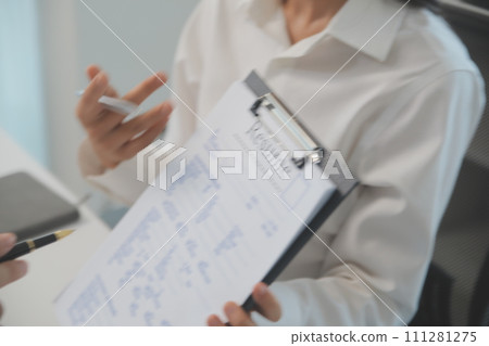 Close up view of job interview in office, focus on resume writing tips, employer reviewing good cv of prepared skilled applicant, recruiter considering application, hr manager making hiring decision 111281275