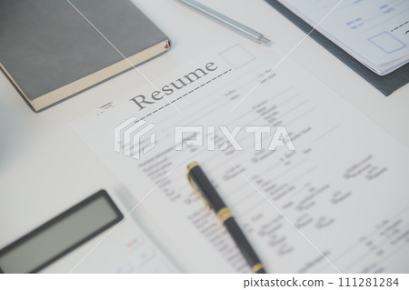 Close up view of job interview in office, focus on resume writing tips, employer reviewing good cv of prepared skilled applicant, recruiter considering application, hr manager making hiring decision 111281284