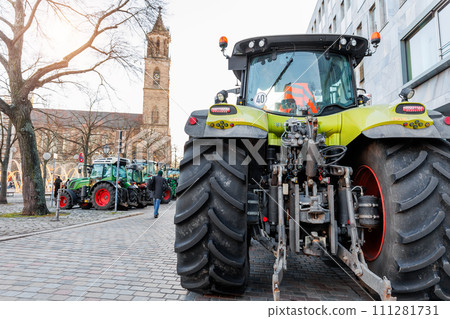 Farmers union protest strike against government Policy in Germany Europe. Tractors vehicles blocks city road traffic. Agriculture farm machines Magdeburg central Domplatz square Farmers union protest strike against government Policy in Germany Europe. Tractors vehicles blocks city road traffic. Agriculture farm machines Magdeburg central Domplatz square 111281731
