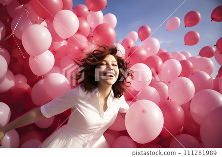 A Symphony of Joy: Young Woman Releasing Myriad Pink Balloons in a Spirited Celebration of Happiness 111281989