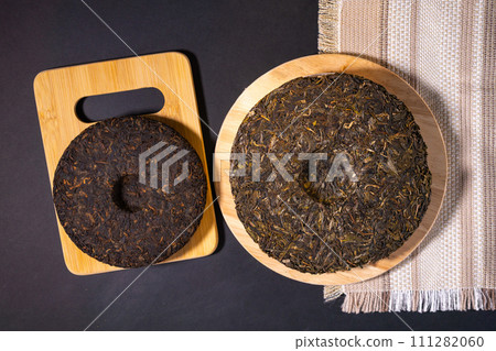 Shaped puerh tea on parchment paper, close up. Traditional ceremony 111282060