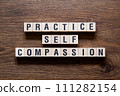 Practice self compassion - word concept on building blocks, text 111282154